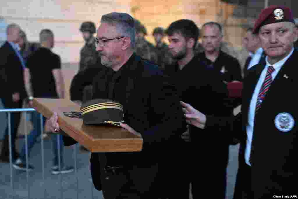Darko Mladić nosi Mladićevu vojnu kapu i vojnu opremu po dolasku sa srpskim vojnikom veteranom kako bi učestvovao u javnoj komemoraciji na dan sahrane.