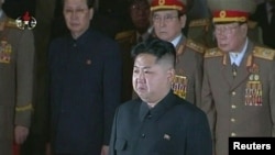 Kim Jong Un, flanked by senior military men, pays his respects to his father, the former North Korean leader Kim Jong Il, lying in state at the Kumsusan Memorial Palace in Pyongyang on December 20.