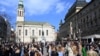 Croatia - People enjoy a sunny day at a square in downtown Zagreb, as Croatian authorities have eased anti-pandemic measures with bars being allowed to sell coffee to go on February 20, 2021.