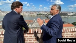 Hungarian Prime Minister Viktor Orban (right) with Fox News host Tucker Carlson in Budapest on August 2.