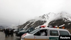 An ambulance on standby near the mountains where an Afghan Pamir Airways plane is thought to have crashed in the Salang pass on May 17.