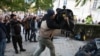 Участник в протеста хвърля чувал с боклук пред сградата на "ДПС - Ново начало".
