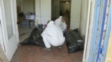 Workers identify the bodies of servicepeople killed in the fighting around Kostyantynivka.