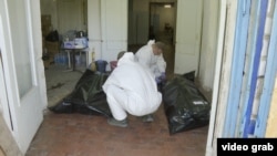Workers identify the bodies of servicepeople killed in the fighting around Kostyantynivka.