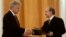 Russian President Vladimir Putin (right) and U.S. President Bill Clinton exchange agreements on the safe disposition of 68 metric tons of weapons-grade plutonium in Moscow on June 4, 2000.