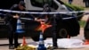 Spanish police officers work near the body of Andriy Portnov, a Ukrainian lawyer who was shot and killed by unidentified gunmen outside a school in Madrid on May 21.