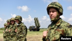 Serbian soldiers stand near a Chinese-made FK-3 medium-range missile syste during the "Shield 2022" military exercises in Batajnica, near Belgrade, in April 2022. 