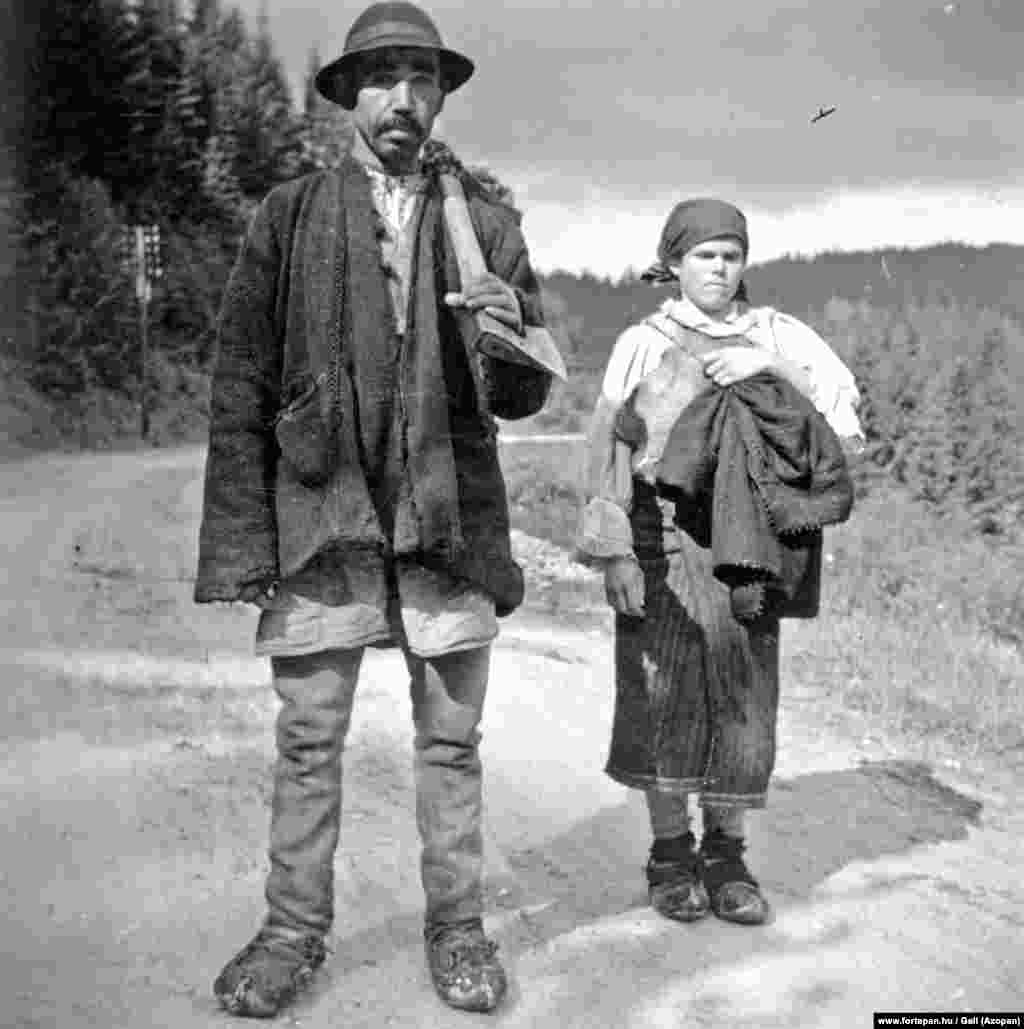 A gigantic woodsman pauses for a photo with his companion on a road near Lacu Rosu in 1940. &nbsp; The archive covers a century of Romanian history from 1900 through 2000. The archivists rely on donated photos to grow the collection. &nbsp;