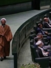 An Iranian cleric lawmaker walks at the parliament during a memorial, in Tehran, Iran, Wednesday, May 21, 2025