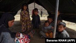 Afghan refugees sit inside a makeshift tent shelter on the outskirts of Quetta on September 6.