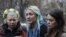 Activists from the Ukrainian women's rights group Femen hold an impromptu press conference on their return to Kyiv (from left to to right: Aleksandra Nemchinova, Inna Shevchenko, and Oksana Shachko). 