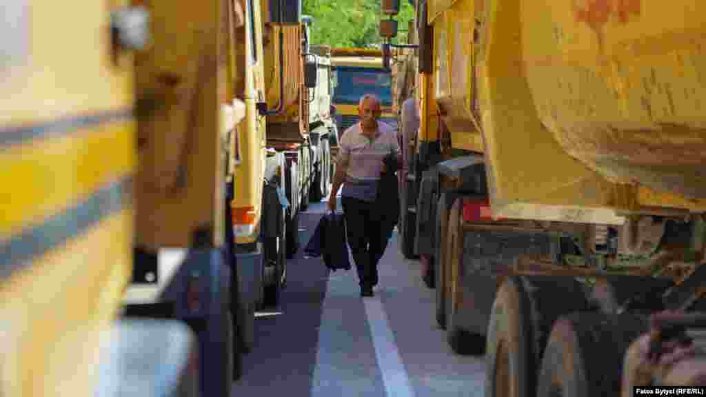 A man passes through trucks placed by local Serbs to block the road in Jarinje on September 26.