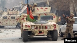 Afghan security forces take position at the site of an attack claimed by Islamic State in Jalalabad on January 24.