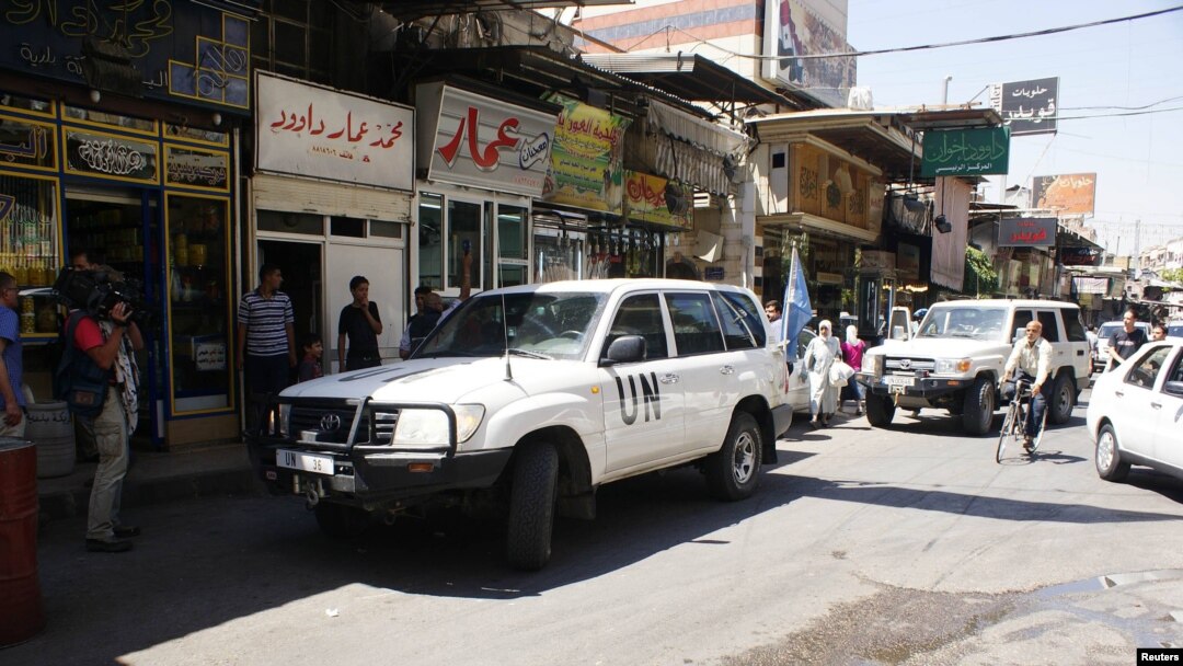 A UN vehicle transports members of the observer mission in Syria during a field visit to Al-Midan market in Damascus on June 12.
