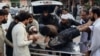 People carry an injured blast victim inside a hospital at Dera Ismail Khan in Pakistan's Khyber Pakhtunkhwa province.