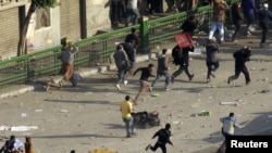 Egypt - An anti-government protester falls as pro-government supporters of Egyptian President Hosni Mubarak clash with anti-Mubarak supporters occupying Tahrir square in central Cairo, 02Feb2011