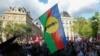 A protester holds the flag of New Caledonian nationalists at a demonstration in Paris on May 16.