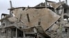 A student walks past rubble of damaged buildings in a rebel-held area in the city of Deraa, Syria January 25, 2018.