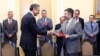 Armenia - Arman Khachaturian (R), head of the National Competitiveness Foundation and Andre Andonian of McKinsey & Company sign an agreement in Yerevan, 18Jul2013.