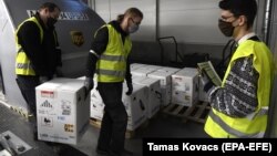 Boxes containing the Pfizer-BioNTech vaccine are unloaded at Budapest Liszt Ferenc International Airport on December 30.