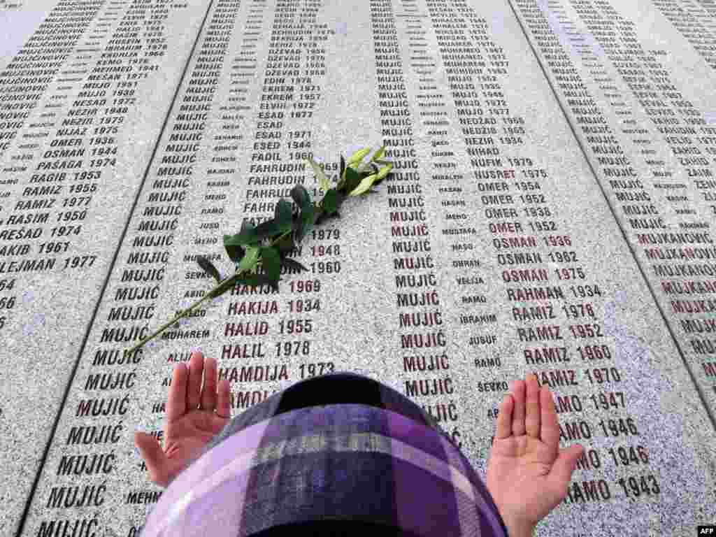 A Bosnian Muslim woman prays at the Potocari memorial cemetery near Srebrenica on March 31. - Serbia's apology for the 1995 Srebrenica massacre on March 31 was greeted with bitterness and cynicism in Bosnia-Herzegovina, where Muslim survivors of the massacre slammed Belgrade for dodging the term "genocide" and Bosnian Serbs felt betrayed. Photo by Elvis Barukcic for AFP