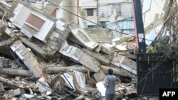 LEBANON - A man looks at the destruction at the site of an overnight Israeli airstrike on the Ruwais neighborhood in Beirut's southern suburbs on October 1, 2024. 