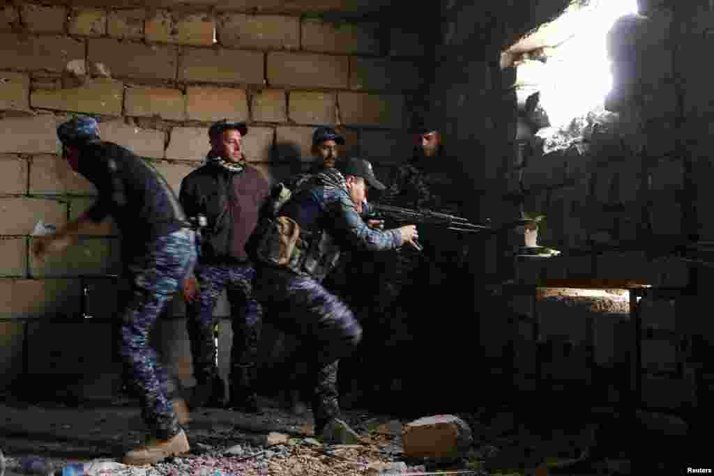 An Iraqi police sniper takes aim from a destroyed building near Islamic State fighters&#39; positions in the old city of Mosul on March 27. (Reuters/Youssef Boudlal)