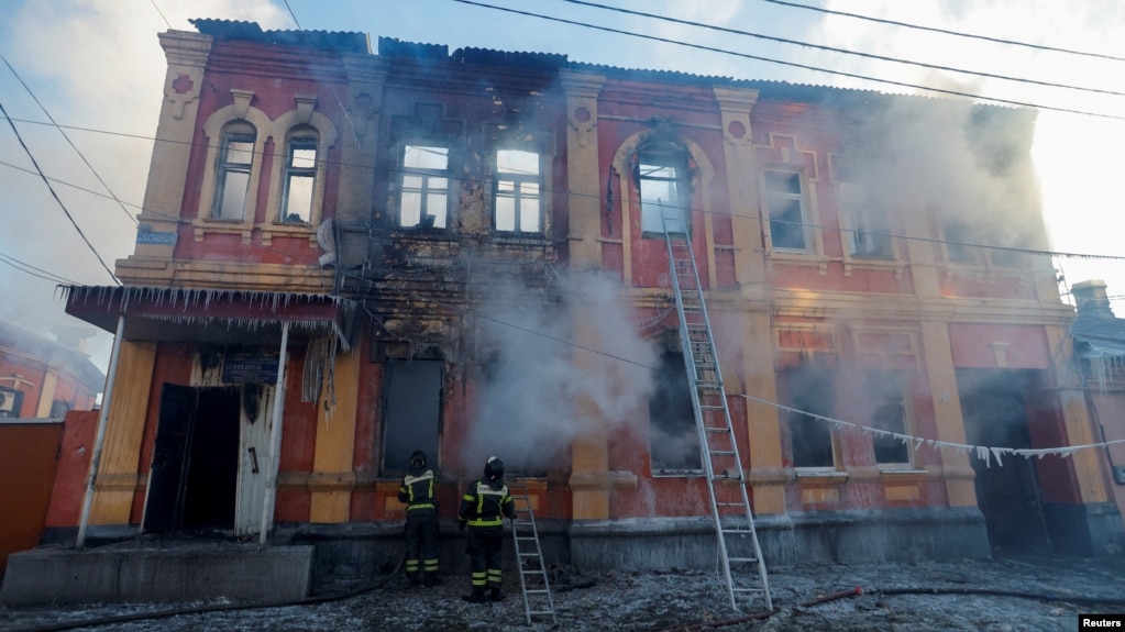 Firefighters work outside an office building destroyed by shelling in Donetsk, Ukraine, on December 5.