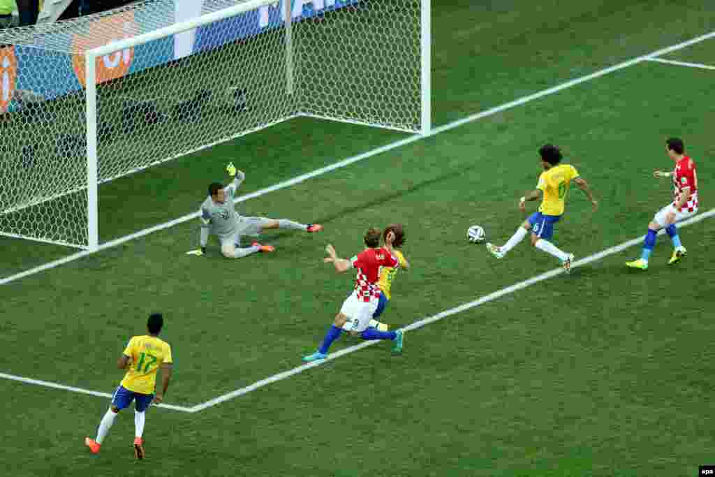 Brazil -- Marcelo (2nd R) of Brazil scores an own goal during the FIFA World Cup 2014 group A preliminary round match between Brazil and Croatia at the Arena Corinthians in Sao Paulo, June 12, 2014
