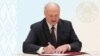 Alyaksandr Lukashenka signs the amendments into law in Minsk on May 24.