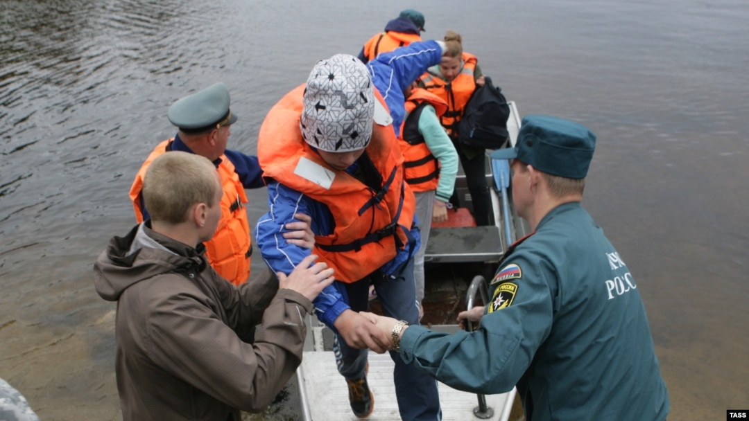 Children return to the Syamozero Park Hotel in Russia's Pryazhinsky District after at least 14 died on a lake when boats capsized on a lake. 