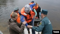 Children return to the Syamozero Park Hotel in Russia's Pryazhinsky District after at least 14 died on a lake when boats capsized on a lake. 