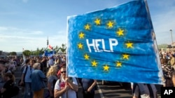 Hungarian demonstrators display a banner during an anti-government protest in Budapest in May 2017.﻿