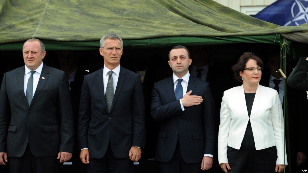 Georgian President Giorgi Margvelashvili (left to right), NATO Secretary-General Jens Stoltenberg, Georgian Prime Minister Irakli Garibashvili, and Georgian Defense Minister Tinatin Khidasheli take part in the inauguration ceremony of the NATO-Georgian Joint Training and Evaluation Center outside Tbilisi on August 27.