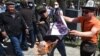 Kyrgyz men burn a placard during an anti-gay rally in Bishkek in April 2021.