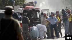 Emergency teams transfer unidentified bodies and injured victims with ambulances after militants attacked a Pakistan Air Force (PAF) base on the outskirts of Peshawar on September 18.