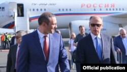 Armenia -- Russian Security Council Secretary Nikolay Patrushev (R) is greeted by his Armenian counterpart Armen Grigorian at Yerevan airport, August 12, 2019.