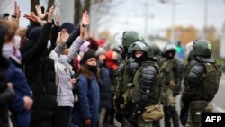 Riot police block protesters during a march of opposition supporters from central Minsk to a site of Stalin-era executions just outside the capital on November 1.