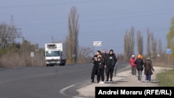 Călători în așteptarea transportului public, pe un traseu în apropiere de Chișinău, 26 martie 2026