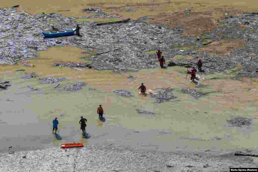 A drone view shows rescue workers searching for victims after floods and landslides in the village of Buturovic Polje, Bosnia and Herzegovina.