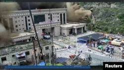 Un val de noroi și apă distruge clădirile dintr-o vale de la granița dintre Nepal și China, în Gyirong (stop cadru din video de supraveghere)