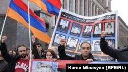 Armenia -- Opposition demonstrators hold up pictures of 10 men killed in the 2008 post-election violence in Yerevan, 1Mar2013.