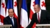 Georgia's President Giorgi Margvelashvili (right) greets his French counterpart Francois Hollande in Tbilisi, May 13, 2014.