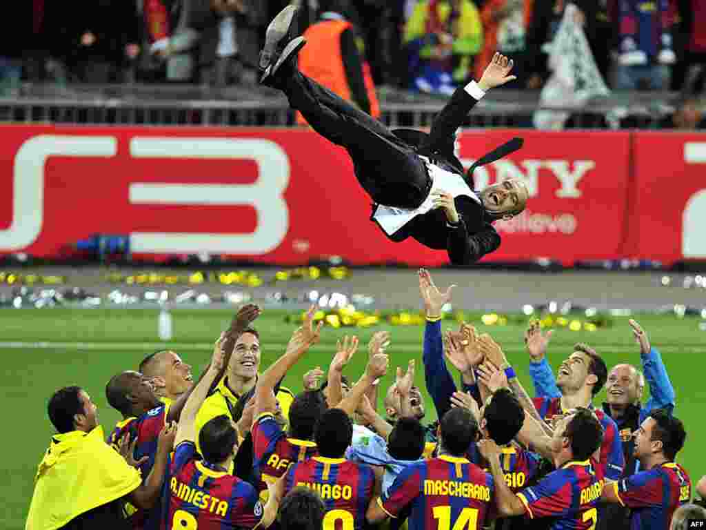 Barcelona soccer coach Pep Guardiola is thrown in the air after his team's Champions League victory on May 29.Photo by Glyn Kirk for AFP