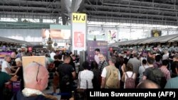 Stranded passengers wait at Bangkok's Suvarnabhumi International Airport on February 28 after Thai Airways canceled 11 European-bound flights.