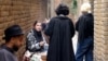 Young Iranians gather at the outdoor smoking area of a cafe in Tehran in February 2025.