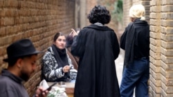 Young Iranians gather at the outdoor smoking area of a cafe in Tehran in February 2025.