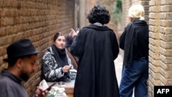 Young Iranians gather at the outdoor smoking area of a cafe in Tehran in February 2025.