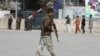 An Afghan soldier walks near the site of an explosion in Kabul in March.