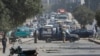 A police vehicle is parked on a road covered with stones thrown by protesters in Karachi on January 7, the fifth day that demonstrations against the killing of 11 Shi'ite Hazara coal miners brought cancellations and delays to roads, railways, and airlines.